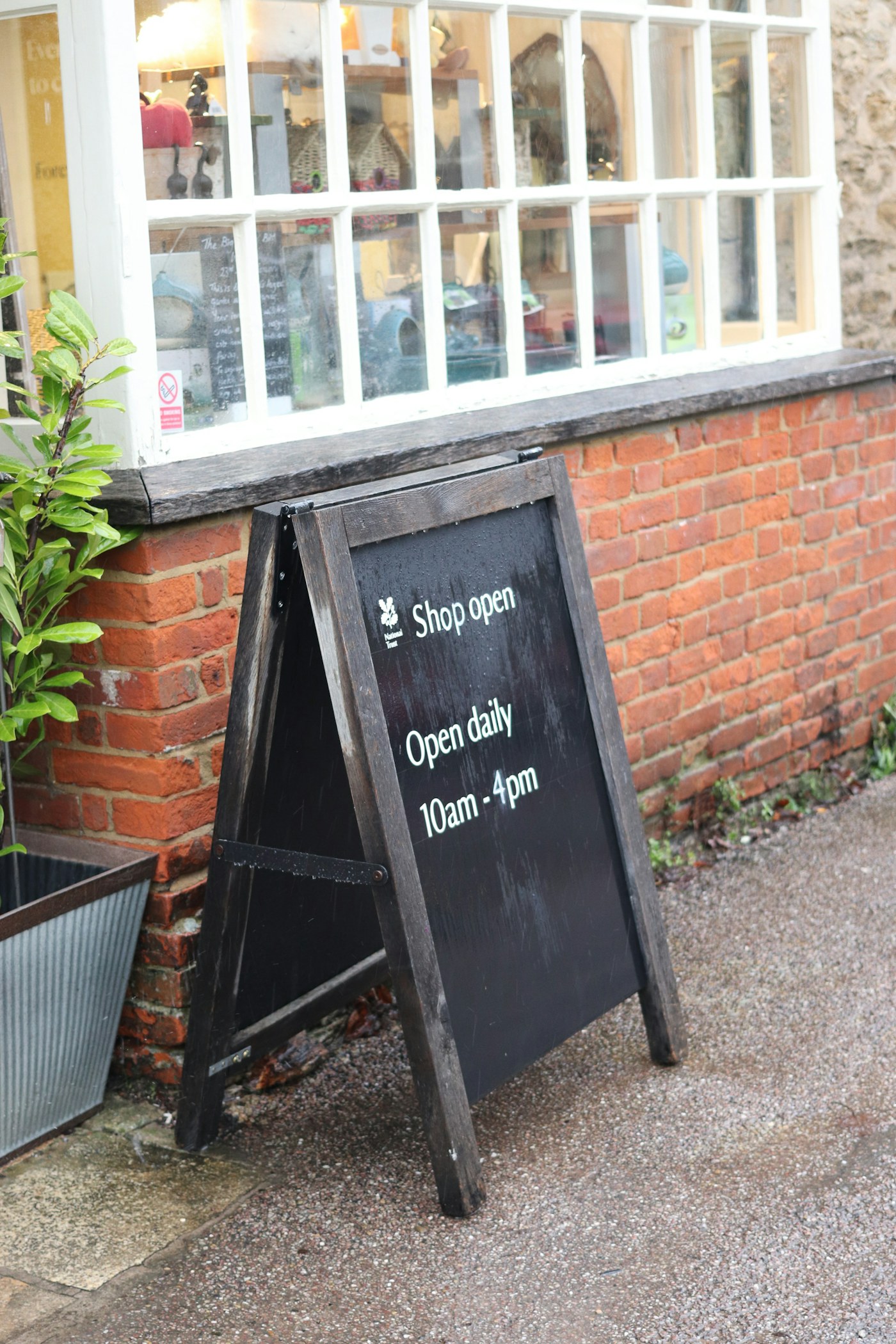 Wooden sandwich board sign outside a neighborhood shop